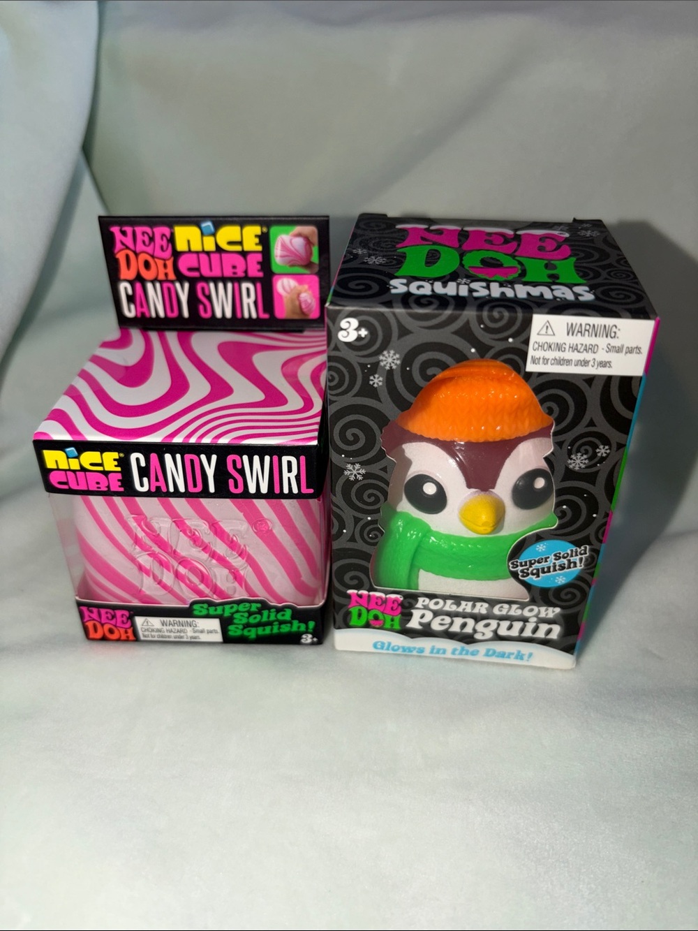 (2) NeeDoh, Polar Glow Penguin Squishy and Candy Swirl Cube